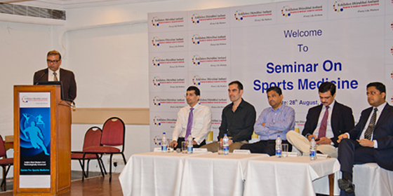 The speakers address the audience